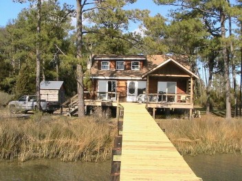 Real Log Cabin On Shallow Winter Harbor