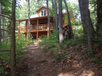 Log Cabin Located In A Serene Setting Of Green Mountains And A Quiet Lake